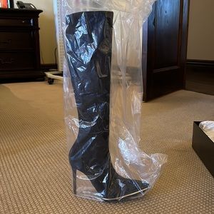Alexander Wang black suede boots width metal silver trim around the tow box.